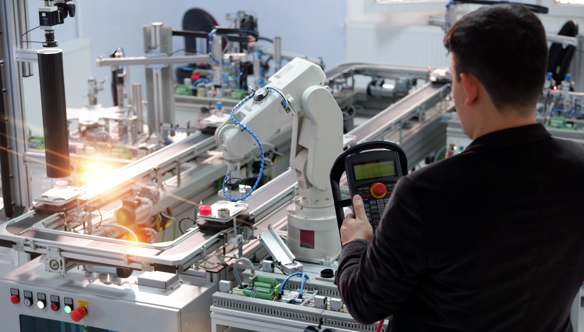industry 4.0 concept: engineer is programming robotic arm